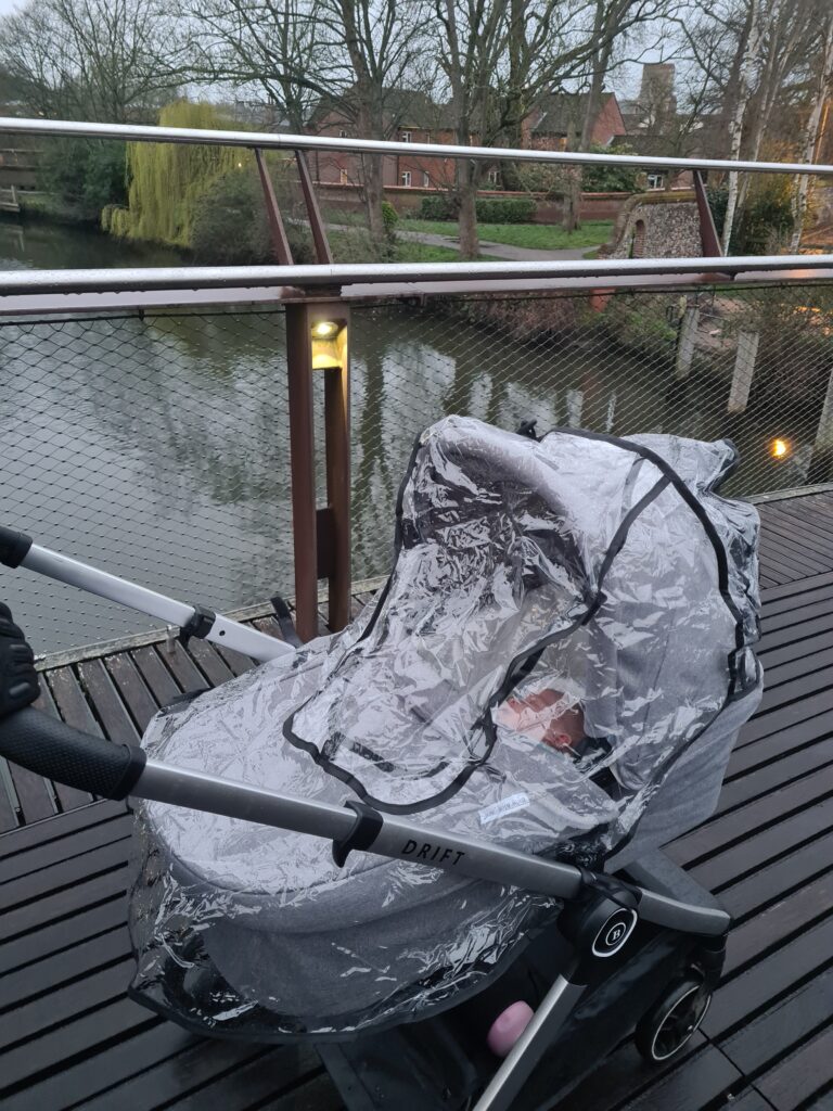 Carry cot with cover in the rain